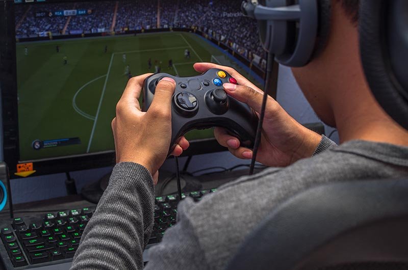 Coca-Cola's Endorsement Deal with Virtual Athlete from FIFA Video Game 1 A gamer playing FIFA | LegalTechMunch