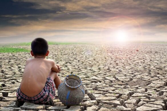 A boy sitting with pot on a barren land due to climate change and looking towards sun I LegalTechMunch