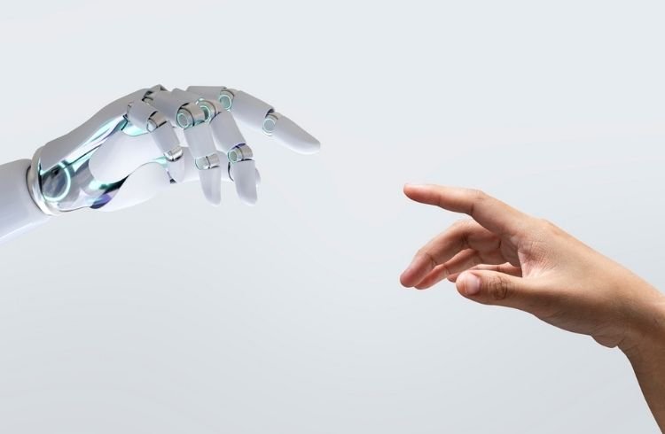 A human hand and a robotic hand coming together