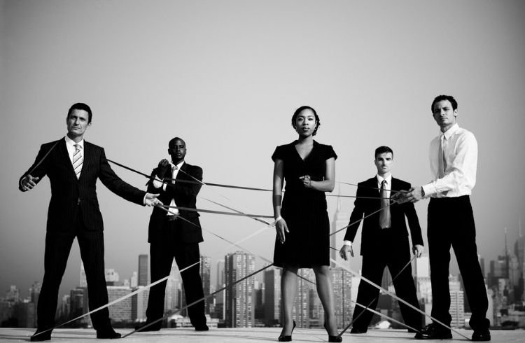 Business people connected by strings.