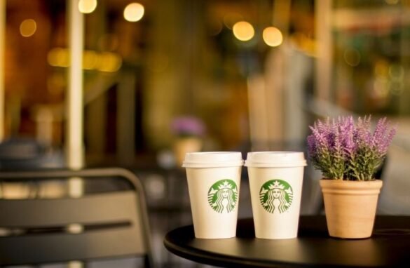 Starbucks paper cups placed on a table