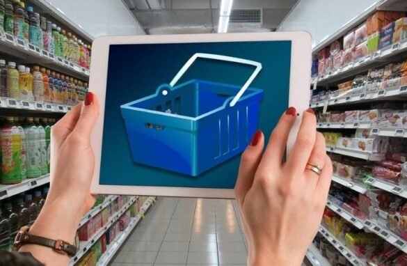 Consumer holding a photo of a shopping cart in a supermarket