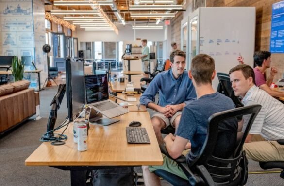 Employees in a tech company discussing a problem