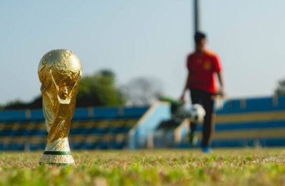 Fifa world cup trophy placed on a football field