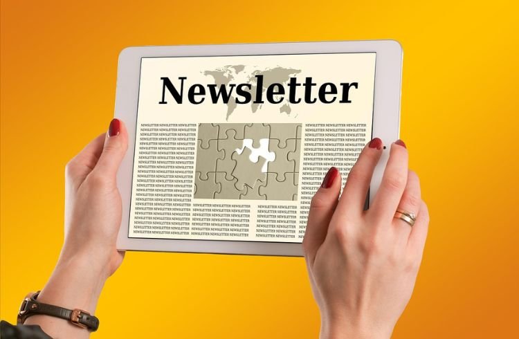 A man opening a newsletter on a tablet