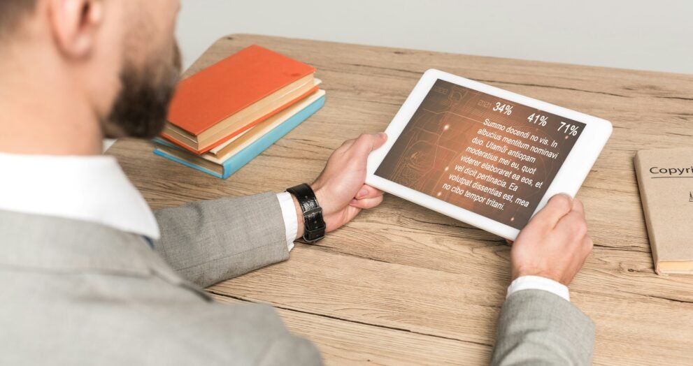 cropped view of businessman using digital tablet with medical app on screen isolated on grey