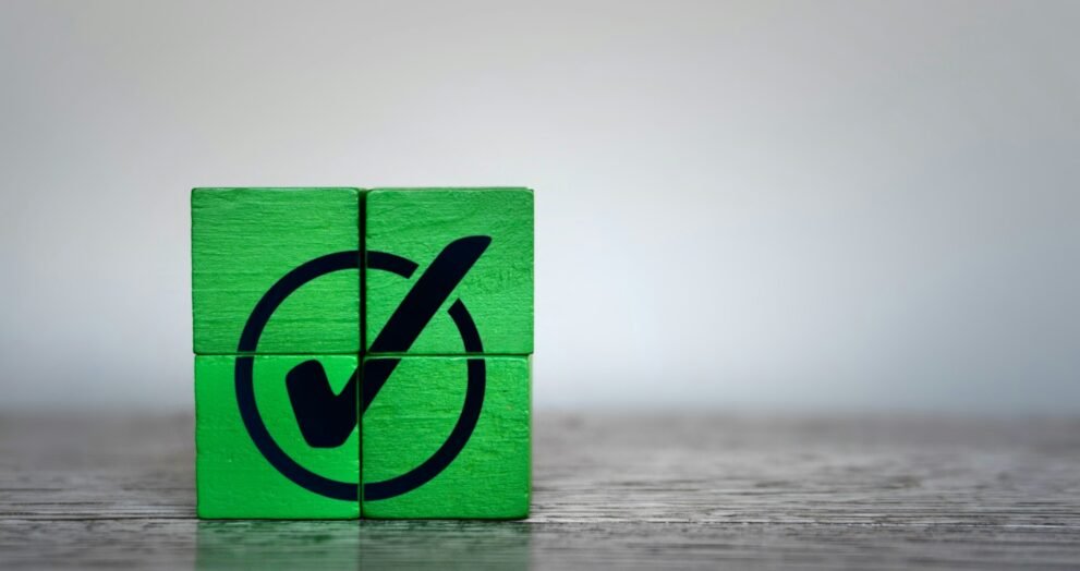 Green wooden cubes with checkmark icon.