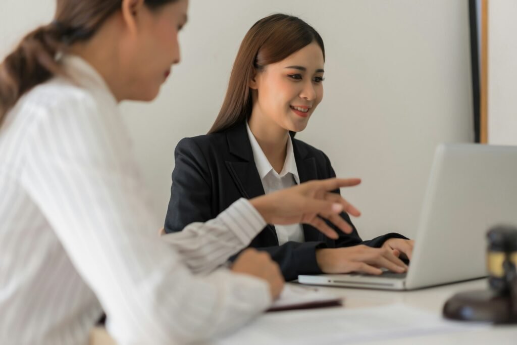 Legal and justice concept, Two female lawyers discussing about contract and typing data on laptop