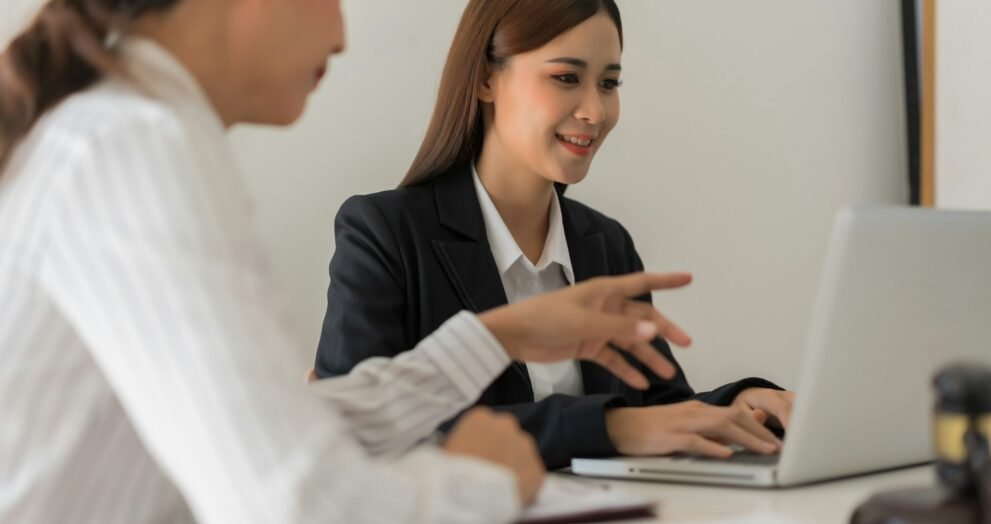 Legal and justice concept, Two female lawyers discussing about contract and typing data on laptop