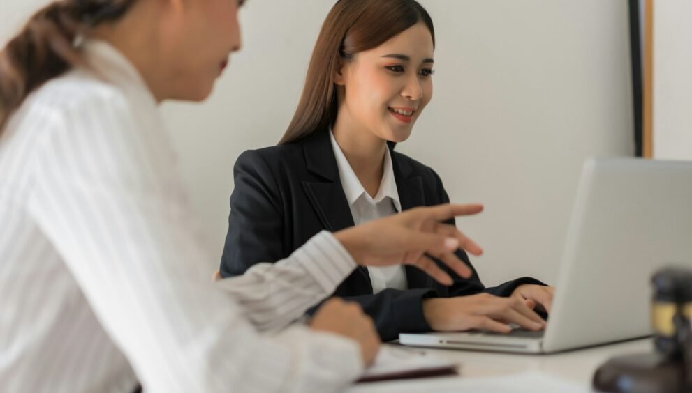 Legal and justice concept, Two female lawyers discussing about contract and typing data on laptop