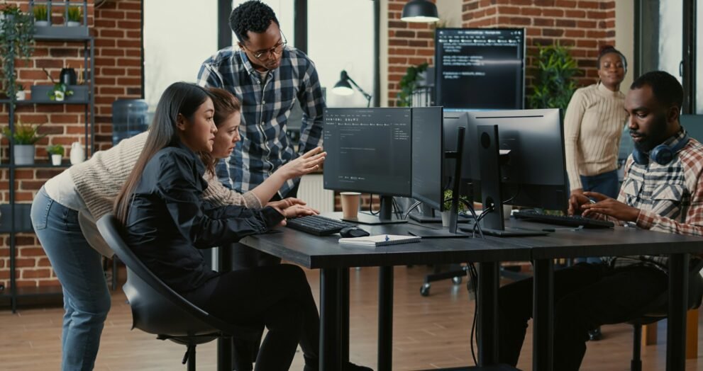 Programmers collaborating on group project compiling algorithm for new cloud computing interface