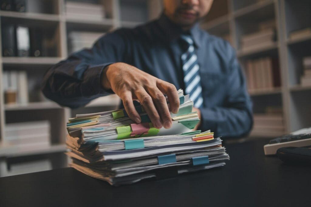 Startup company employees are rummaging through piles of paperwork for performance summaries, employ