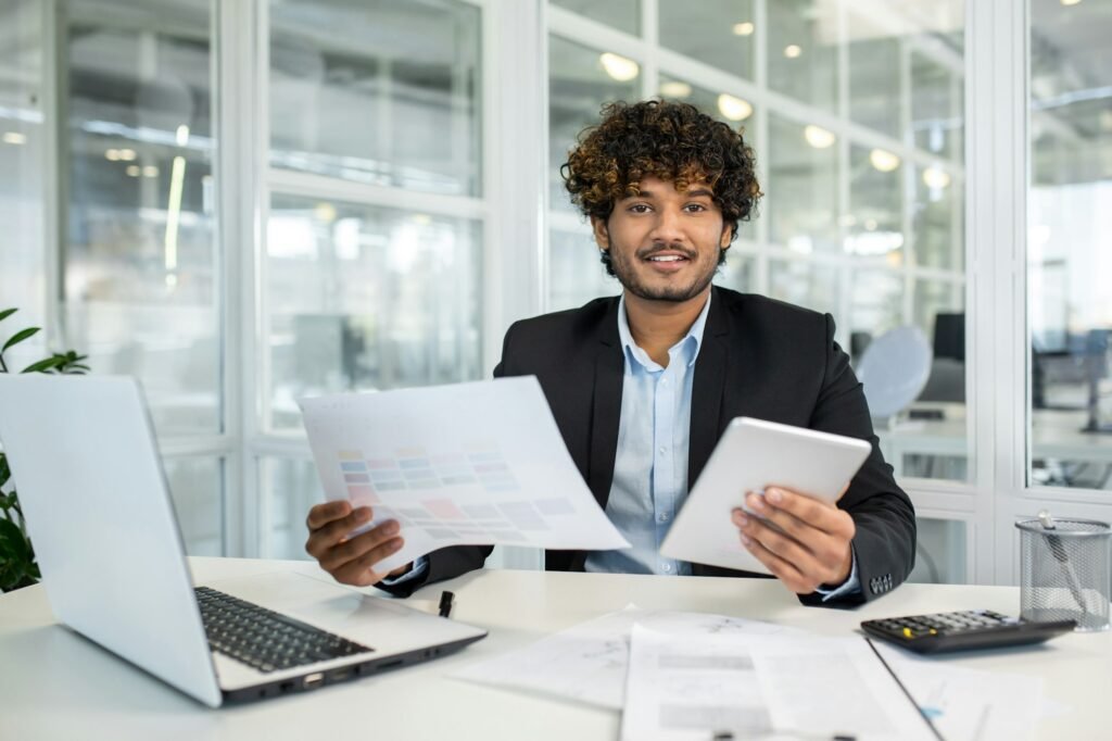 Successful muslim lawyer processing documents while working by portable computer in cabinet